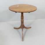 A 19th century circular tilt-top occasional table, on turned central column with tripod base.