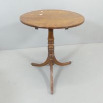 A 19th century circular tilt-top occasional table, on turned central column with tripod base.