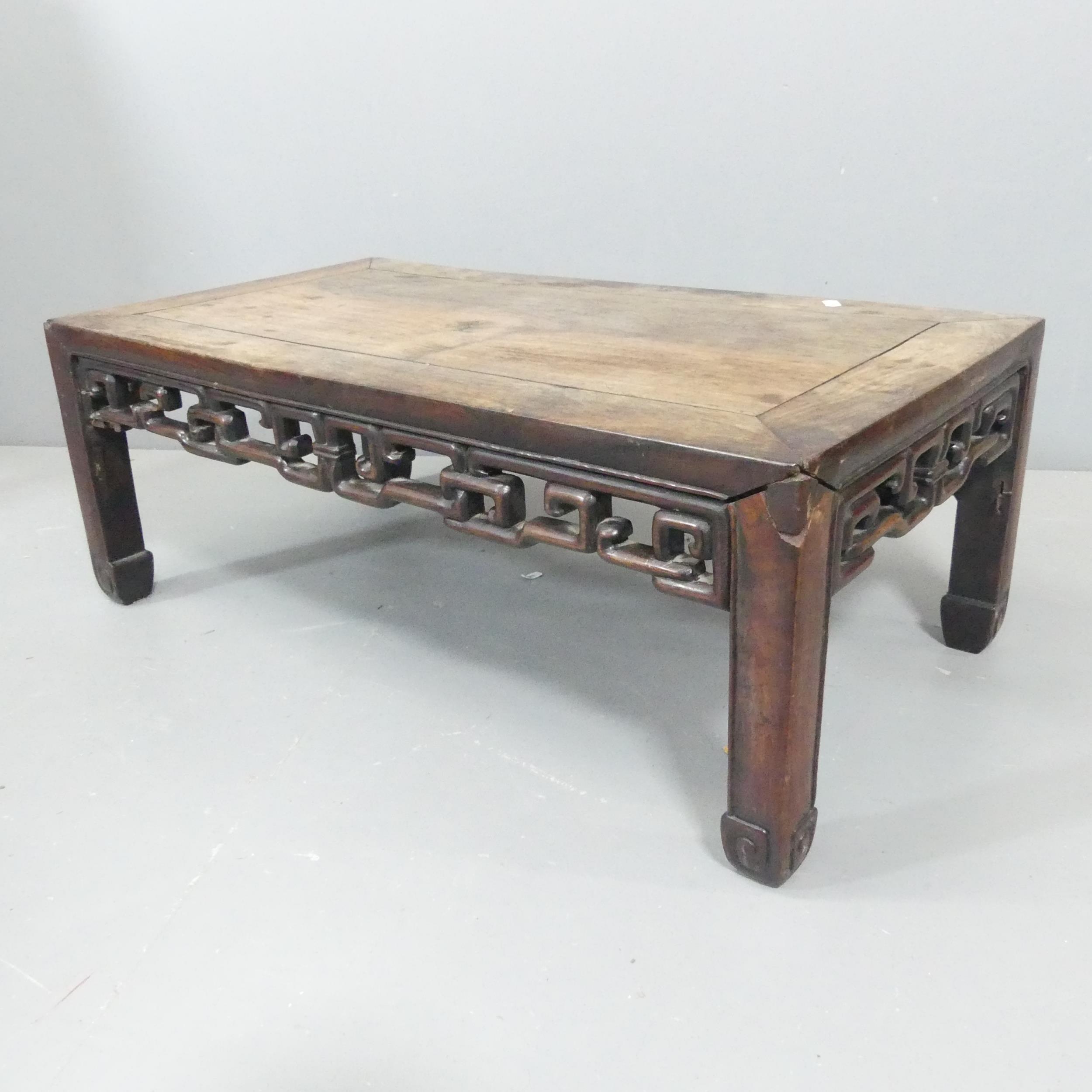 A Chinese hardwood low rectangular coffee table with carved decoration. 77x29x42cm.