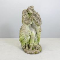 A weathered stone garden statue, study of a dancing couple. Height 68cm.