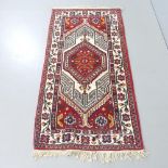 A red-ground Persian design rug. 150x77cm.