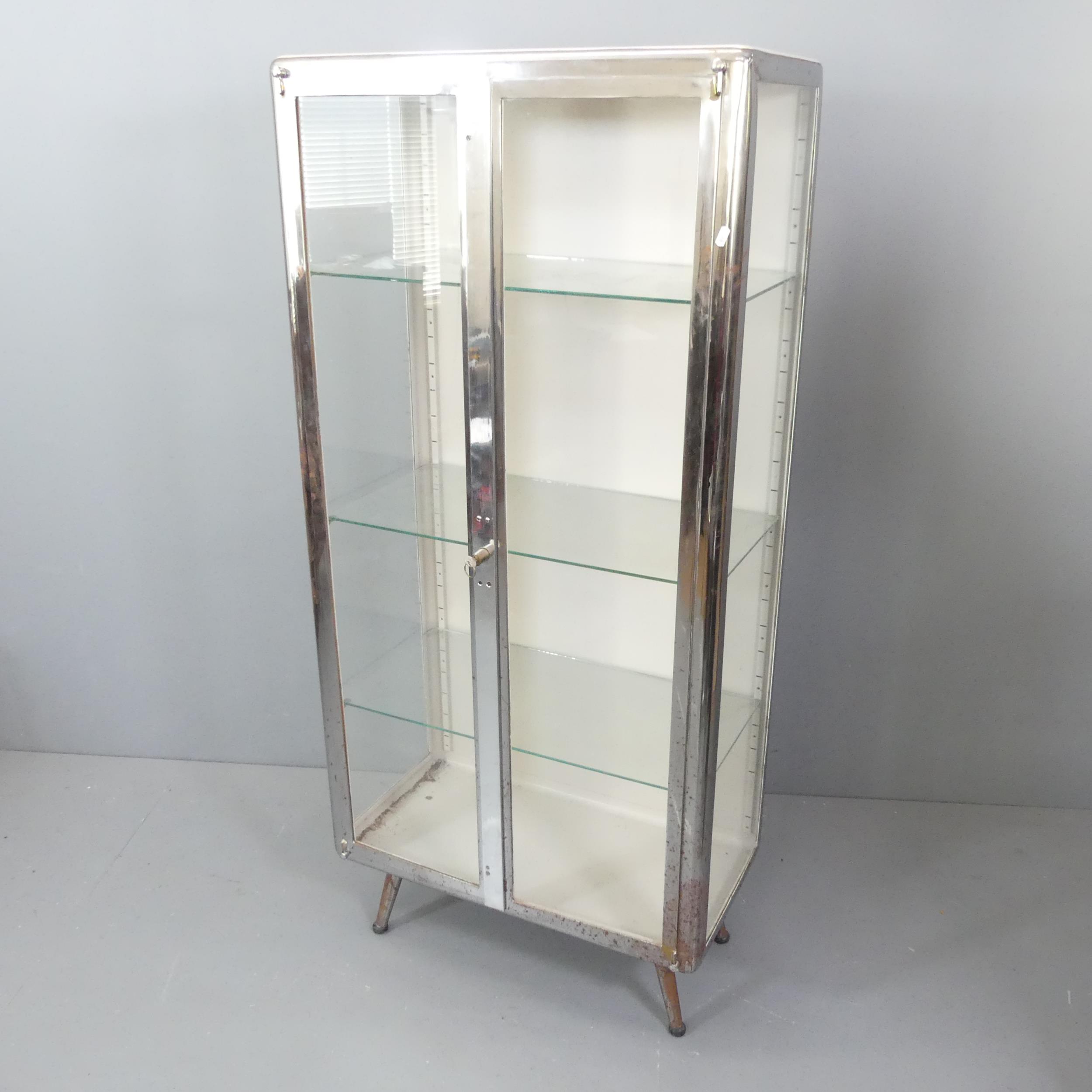 A 1950s glazed medical or dentist's cabinet, with 3 adjustable shelves.75x165x41cm.