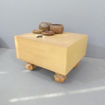 A Japanese Go board and stones. 42x31x46cm.