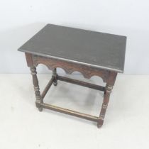 An antique oak side table, with carved decoration and all-around stretcher. 67x69x45cm.