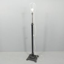An early 20th century standard lamp with cast painted metal base and rise-and-fall mechanism. Height