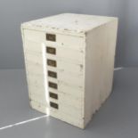 A painted pine bank of seven drawers, with brass campaign-style handles. 68x95x79cm.