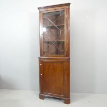 A Georgian-style mahogany two-section corner cabinet. 71x197x43cm.
