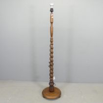 An oak standard lamp, with spiral turned column on platform base. Height to bayonet 143cm.