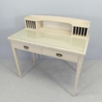 A painted pine writing table, with raised back. two drawers and raised on square tapered legs.