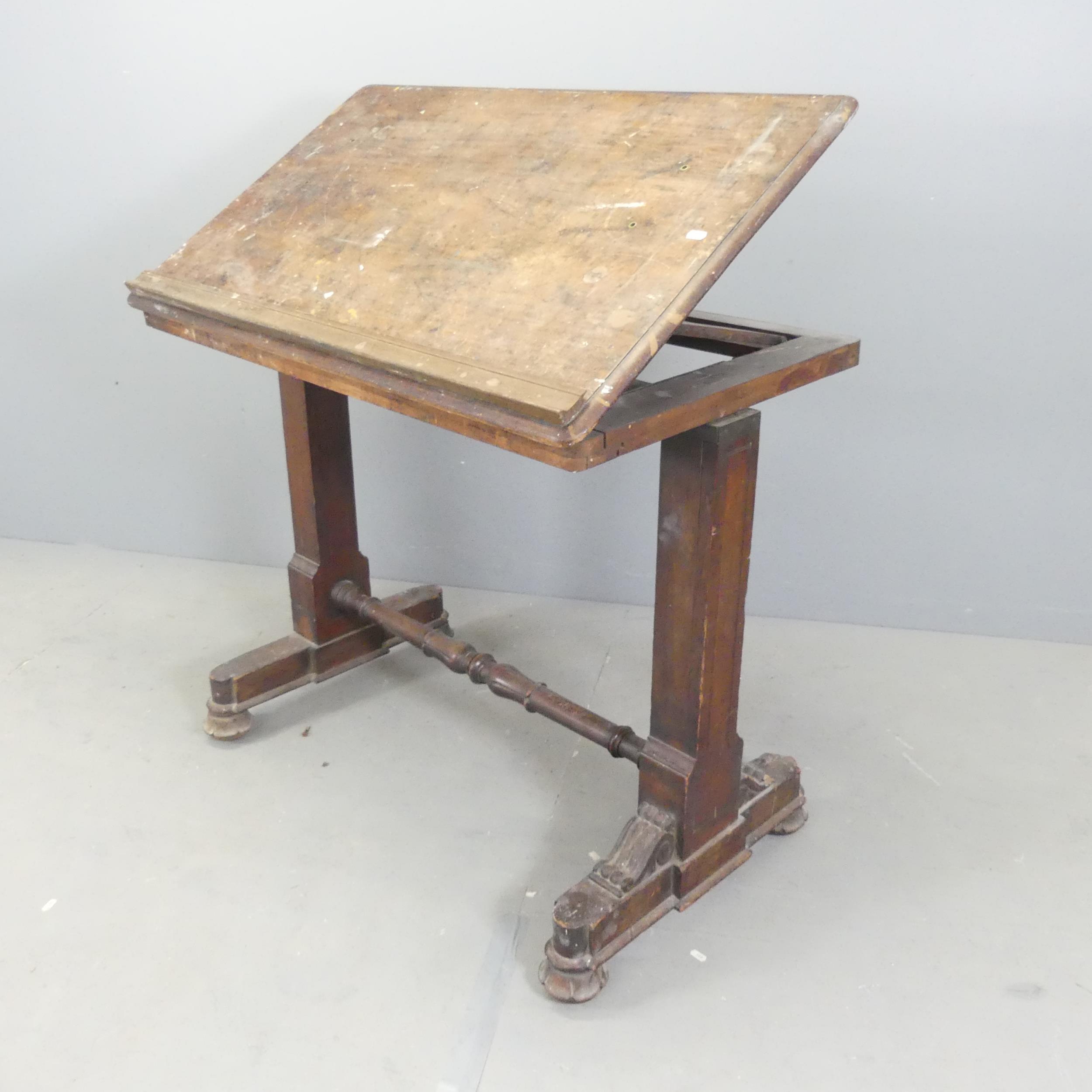 A 19th century oak adjustable Architect's table, with lifting top and adjustable stand.
