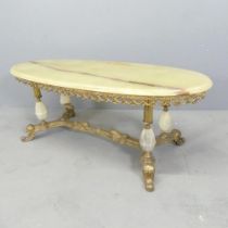 An oval onyx topped coffee table on gilt metal base. 120x45x50cm.