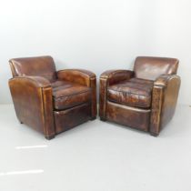 A pair of French Art Deco style leather club chairs in the manner of Jacques Adnet. Overall