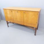 MEREDEW - A mid-century teak sideboard, with three cupboards and drawers under, with maker's
