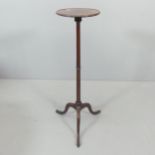 A 19th century mahogany torchere, raised on central column with tripod base. Marked CC to base.