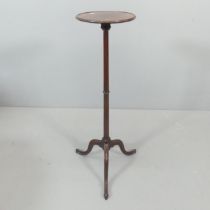 A 19th century mahogany torchere, raised on central column with tripod base. Marked CC to base.