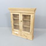 A vintage pine hanging cabinet. 67x77x18cm.