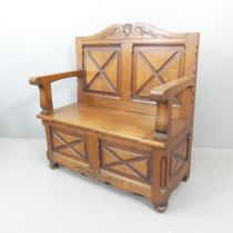 A carved oak hall bench. Overall 103x108x54cm, seat 86x46x40cm.