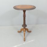 A Victorian mahogany and walnut circular topped occasional table, with carved decoration and
