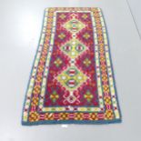 A blue-ground tufted wool Kazak rug. 180x90cm.