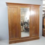 WYLIE AND LOCHHEAD - An Arts and Crafts oak triple wardrobe, possibly designed by John Ednie, with