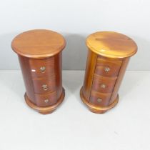 A pair of modern teak three-drawer drum bedside chests. 40x67cm.