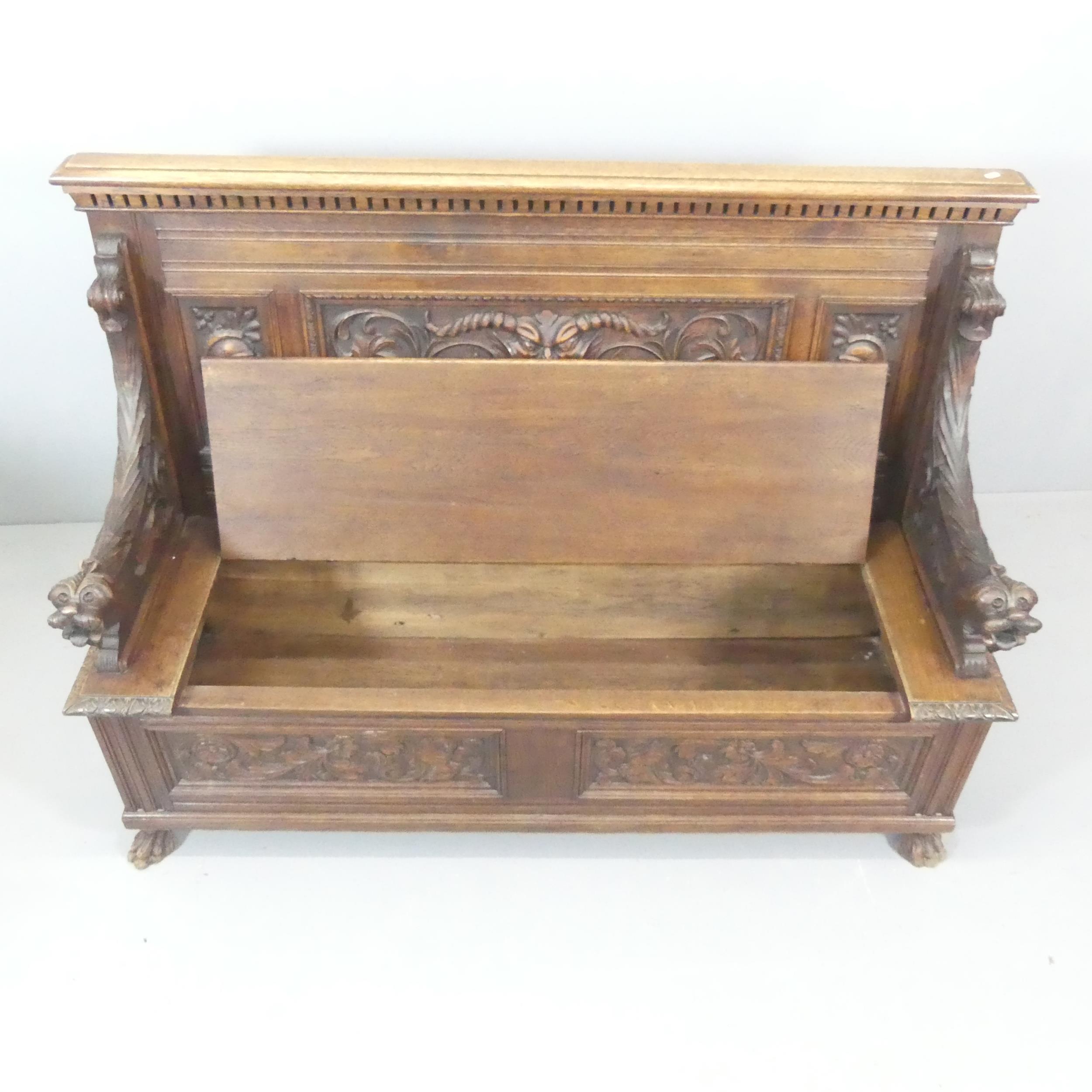 A 19th century oak hall bench, with all over carved decoration and lifting storage seat. - Bild 2 aus 2