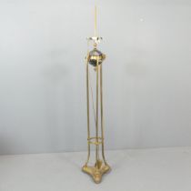 An Empire style brass standard lamp, with marble ball and and rams-head mounts. Height overall