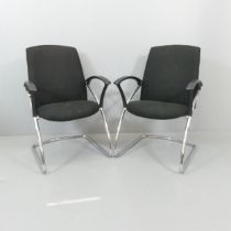 A pair of contemporary office chairs, with upholstered seats on tubular metal frames. Labelled