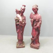 Two Chinese painted stone garden sculptures, including a study of a man holding a dragon, and a lady