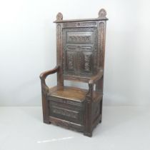 Antique carved and panelled oak hall settle, with rising seat, width 76cm, height 152cm Legs do