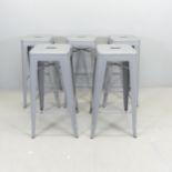 A set of five painted metal Tolix-style stacking stools. Height 76cm.