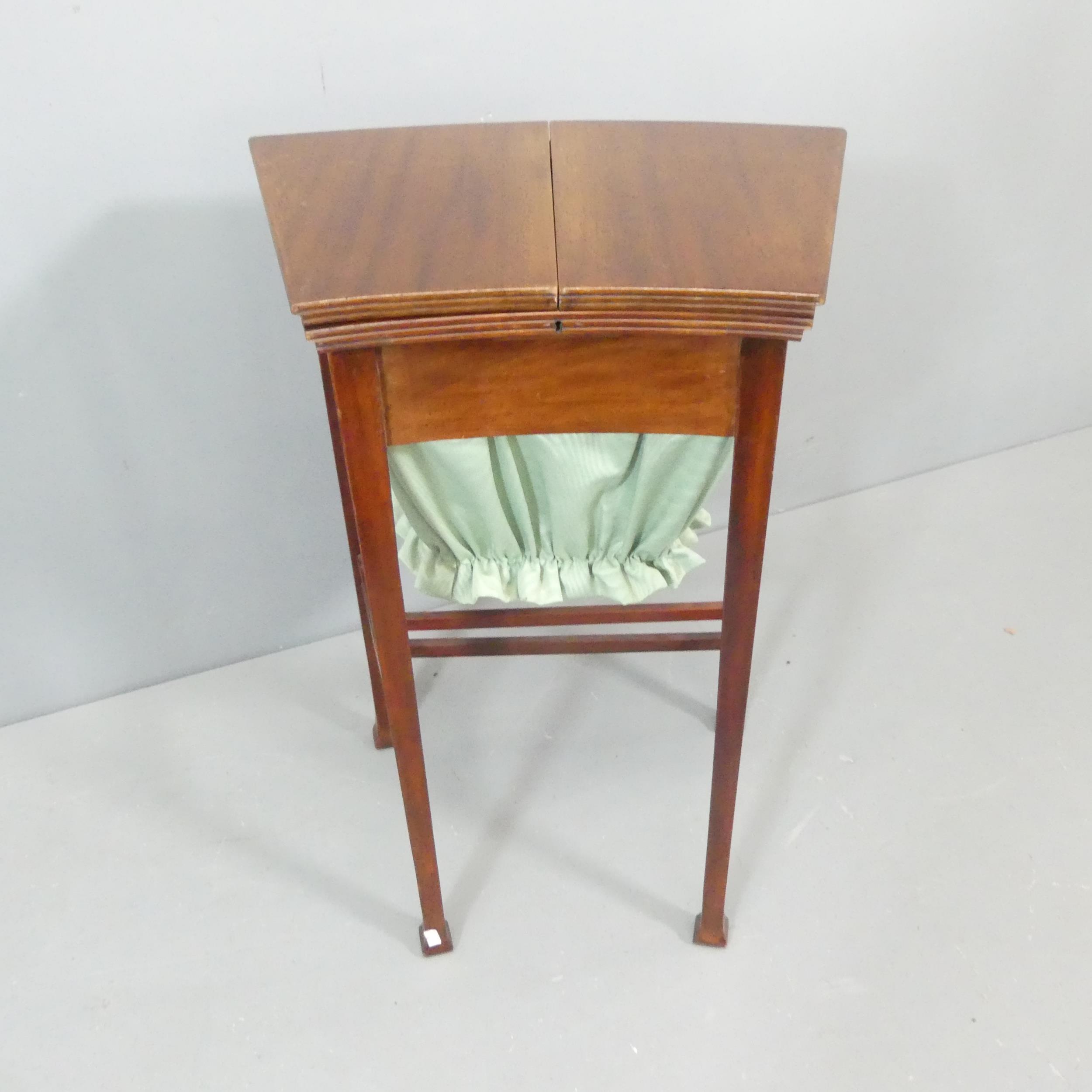 An Edwardian Arts & Crafts work table in the manner of Liberty, the top opening to reveal a fitted - Image 2 of 2