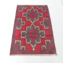 A red-ground Baluchi rug. 135x90cm.