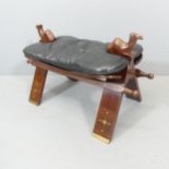 A mahogany camel saddle stool, with leather seat and inlaid brass decoration. 75x45x42cm.