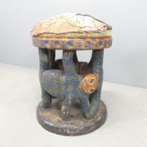 A painted African tribal stool. 40x52cm.