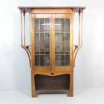 An Arts & Crafts / Art Nouveau display bookcase cabinet in the manner of Liberty & Co. 140x194x36cm.