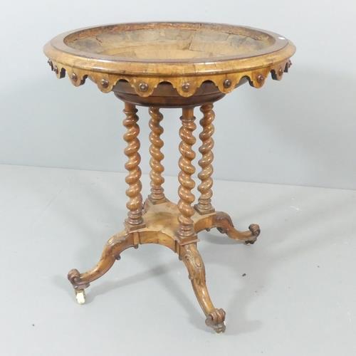 A 19th century walnut font, with carved decoration, and supported on quadruple barley twist