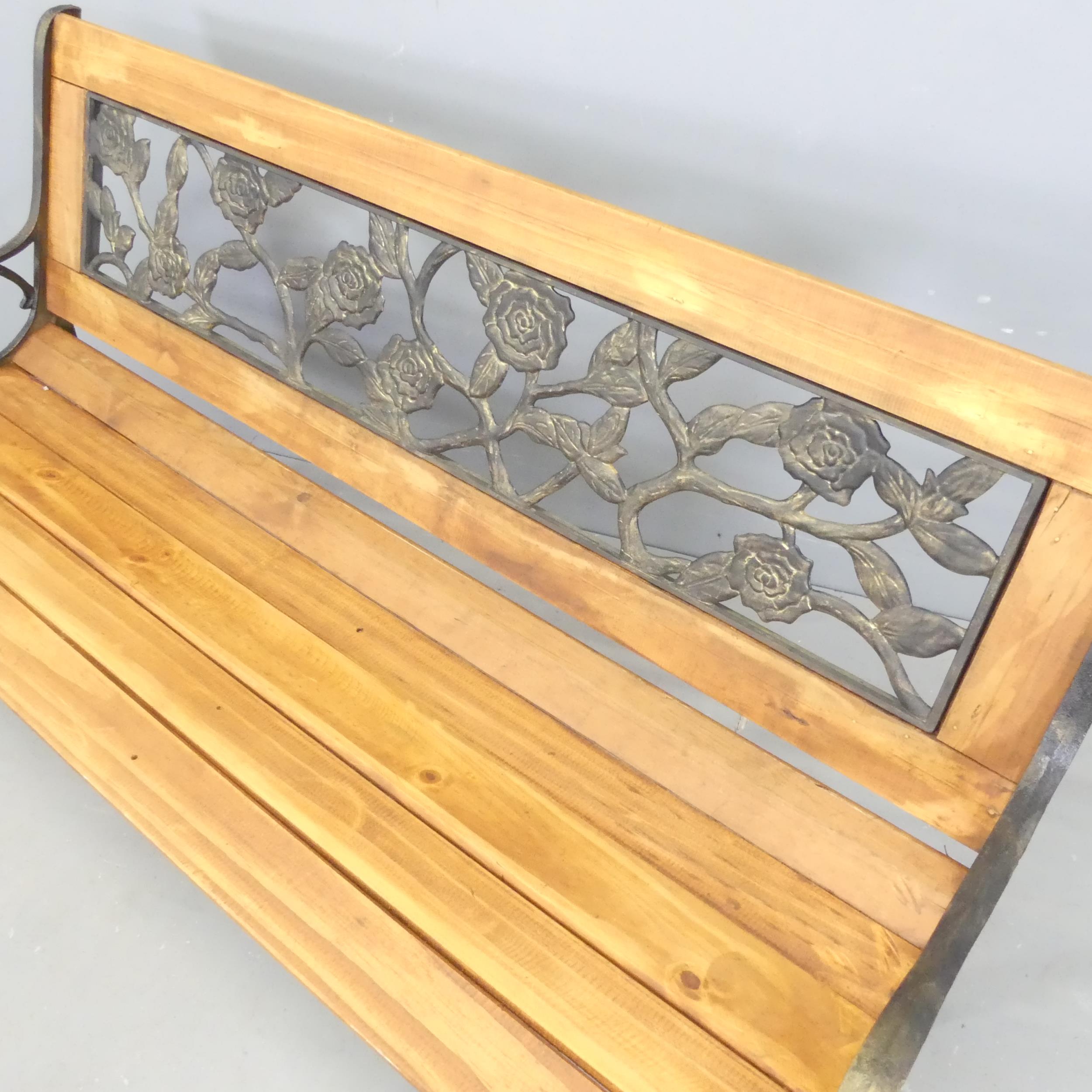 A modern pine slatted garden bench, with inset gilt-resin foliate panel to back. Overall - Image 2 of 2