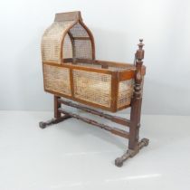 A William IV mahogany and cane rocking crib. 105x120x46cm.