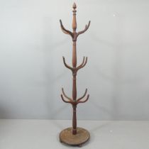 A Regency mahogany hat and coat stand, on circular pedestal base and surmounted with acorn finial.