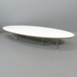 An elliptical surfboard coffee table in the manner of Charles and Ray Eames. 179x26x58cm.