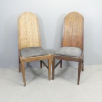 A pair of rustic Arts & Crafts style hardwood high back hall chairs, with butterfly cleated joints