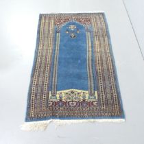 A blue-ground Persian prayer rug. 150x93cm. Repair visible to base.