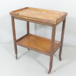 A 1920s oak "Chevin" two tier trolley with fold-over games top, with label. 68x78x40cm. Some water