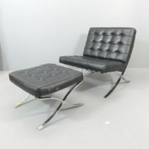 A contemporary black faux-leather upholstered Barcelona style lounge chair, with matching footstool.