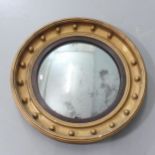 A 19th century Gilt-gesso framed circular convex wall mirror. Diameter 67cm. One ball decoration