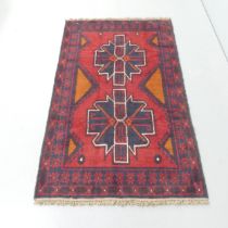 A red-ground Baluchi rug. 146x90cm.