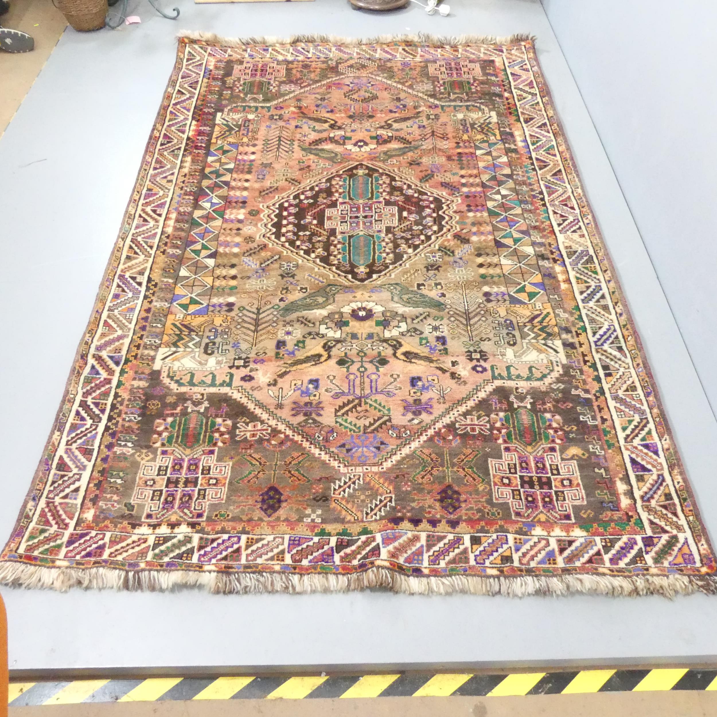 A handmade Persian Shiraz Qashqai rug with bird motifs. 265x169cm