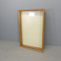 A pine framed table-top display cabinet. 65x95cm. Should be a hanging cabinet, but has no shelves.