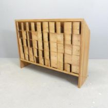 A handmade pine and plywood 50 door seed cupboard. 60x90x23cm.